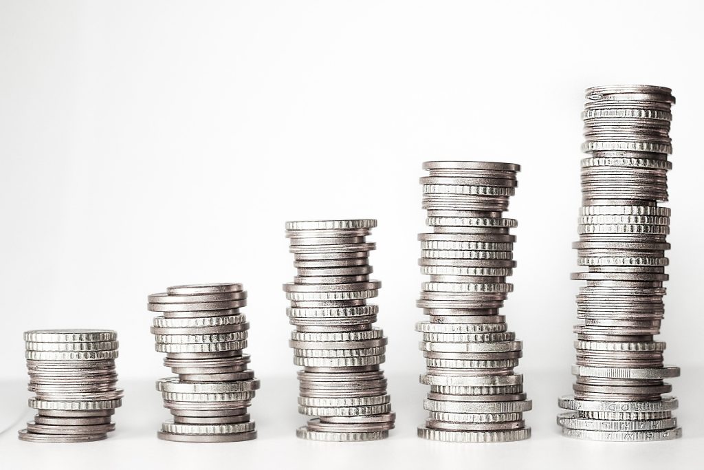 Stacked coins symbolizing commission split tracking and real estate earnings
