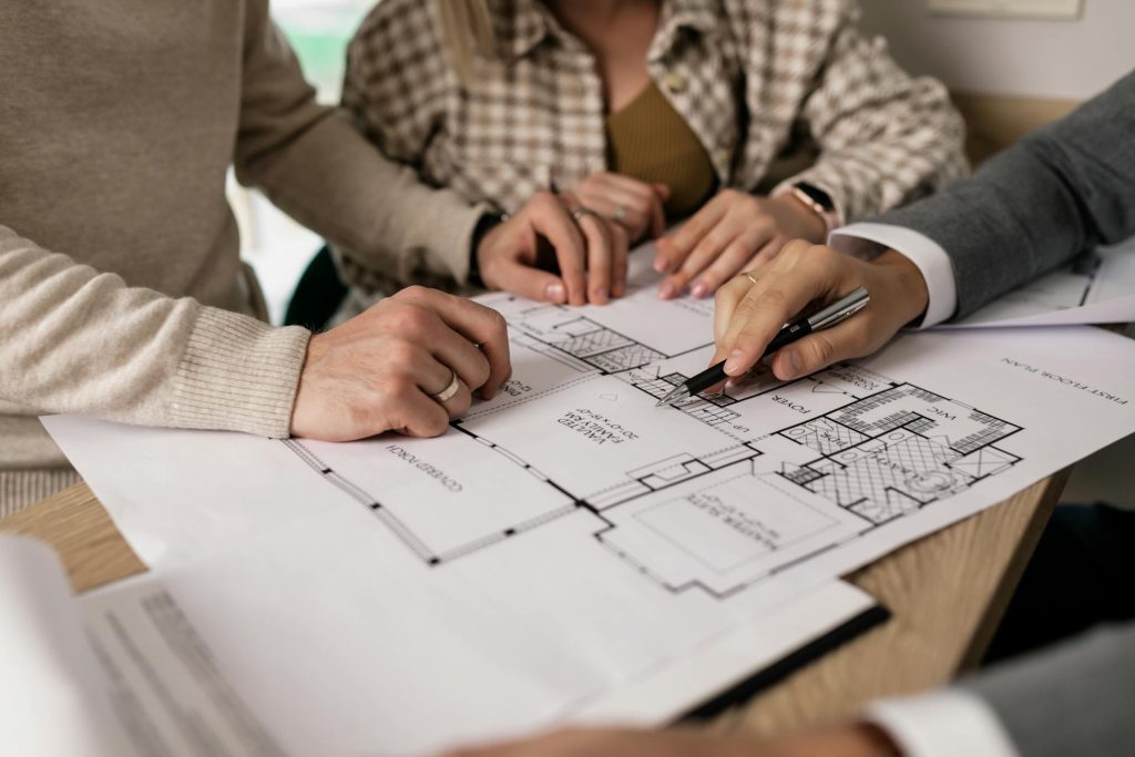 Team reviewing architectural floor plans for property feature and tag management