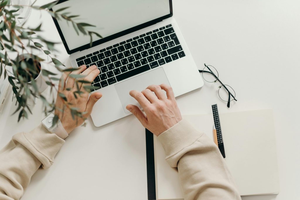 Professional typing on laptop while working on real estate tasks in Toronto