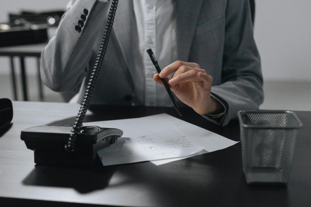 Real estate office worker managing phone call and documentation in Toronto