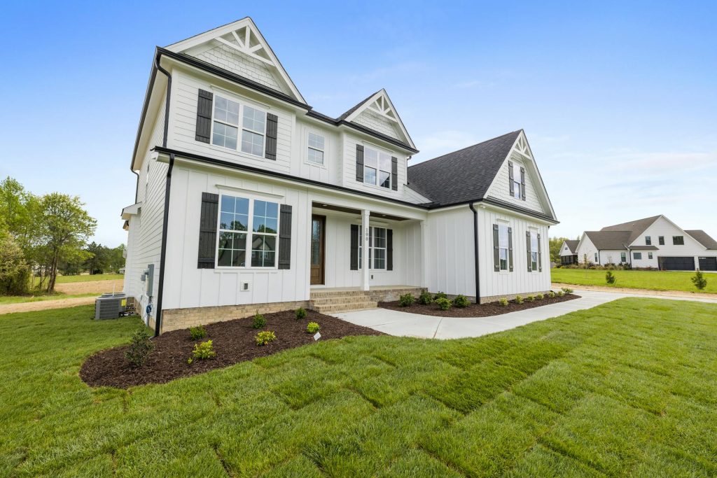 Modern suburban house with green lawn representing Toronto real estate listing upload