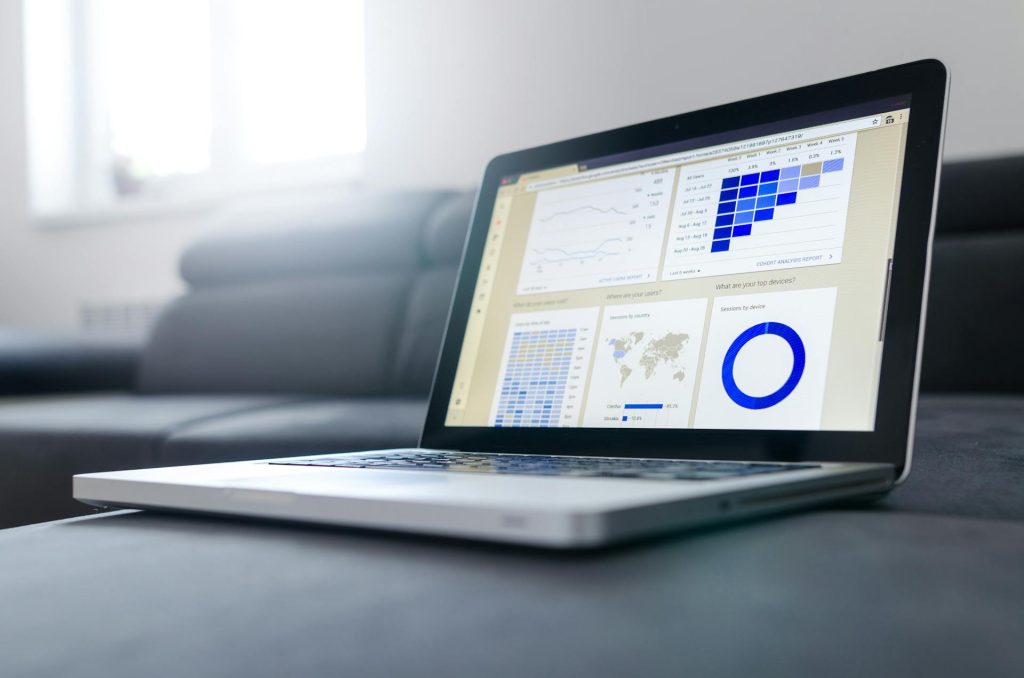 Laptop screen showing financial charts and reports for Toronto real estate compliance