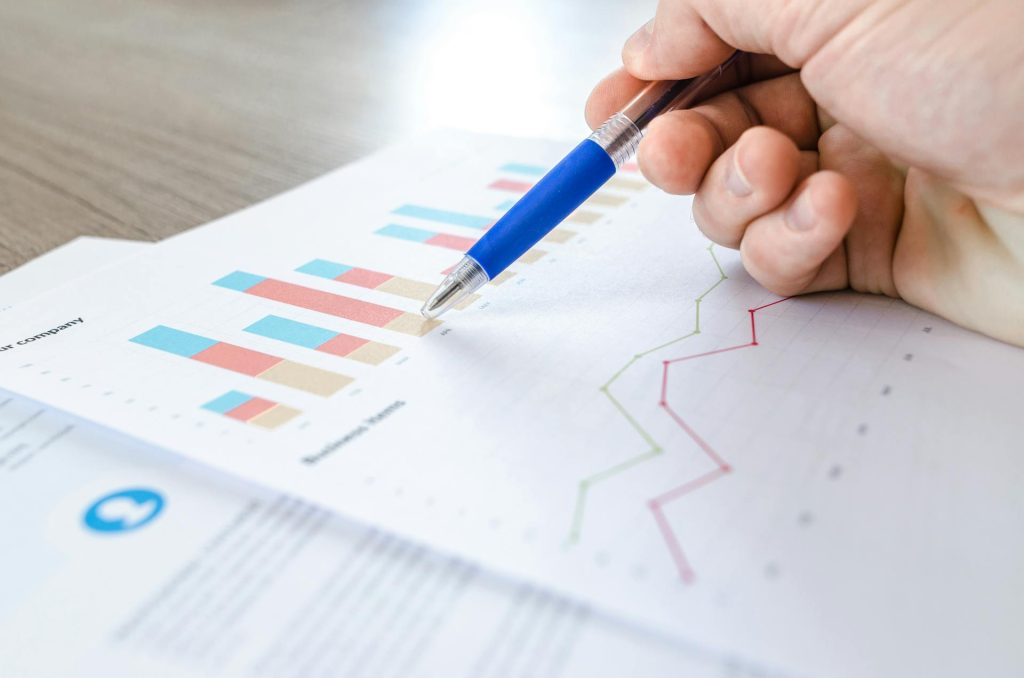 Business professional analyzing financial charts for brokerage reporting