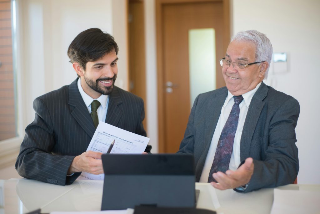 Real estate advisor meeting with senior client to review investment documents in Toronto