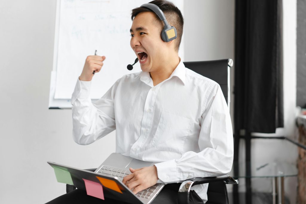 Excited professional celebrating success during an online real estate consultation in Toronto
