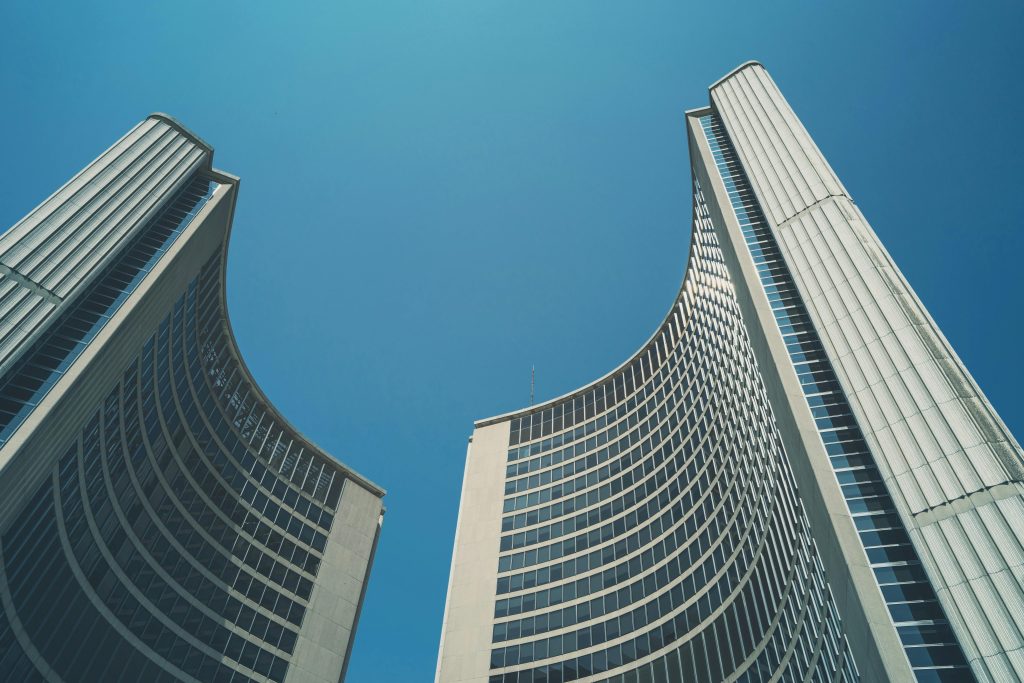 Toronto City Hall twin towers against a clear blue sky