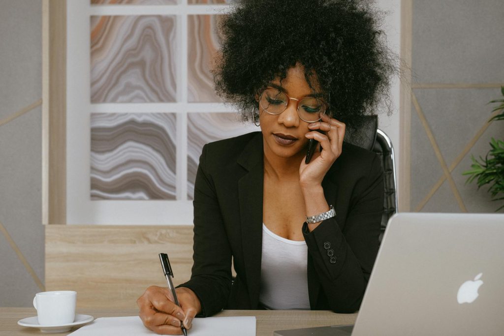 Real estate agent following up with clients by phone in Toronto office