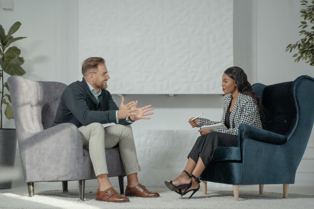 Business consultation between a man and woman discussing real estate services in Toronto