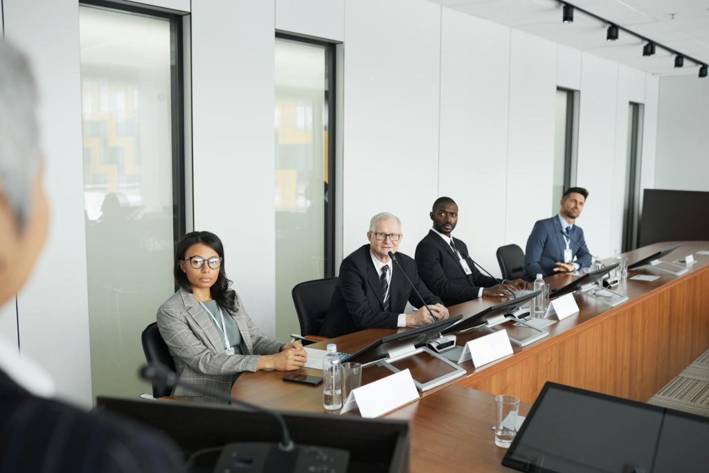 Stakeholders in formal business meeting discussing communication strategies
