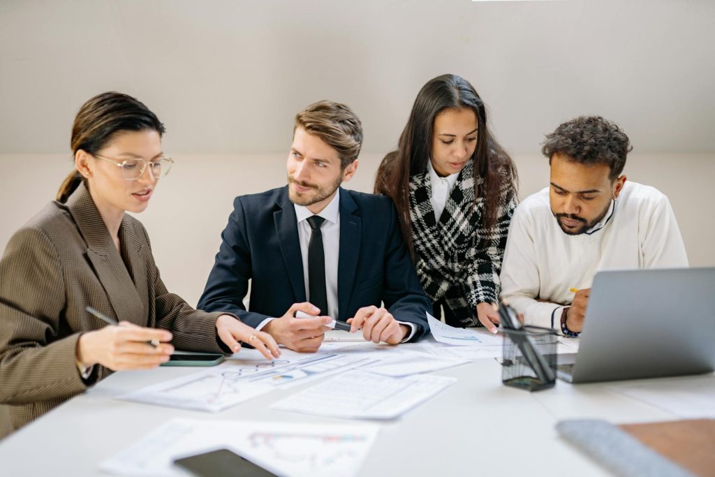 Group of business professionals planning legacy and post-exit strategies with paperwork